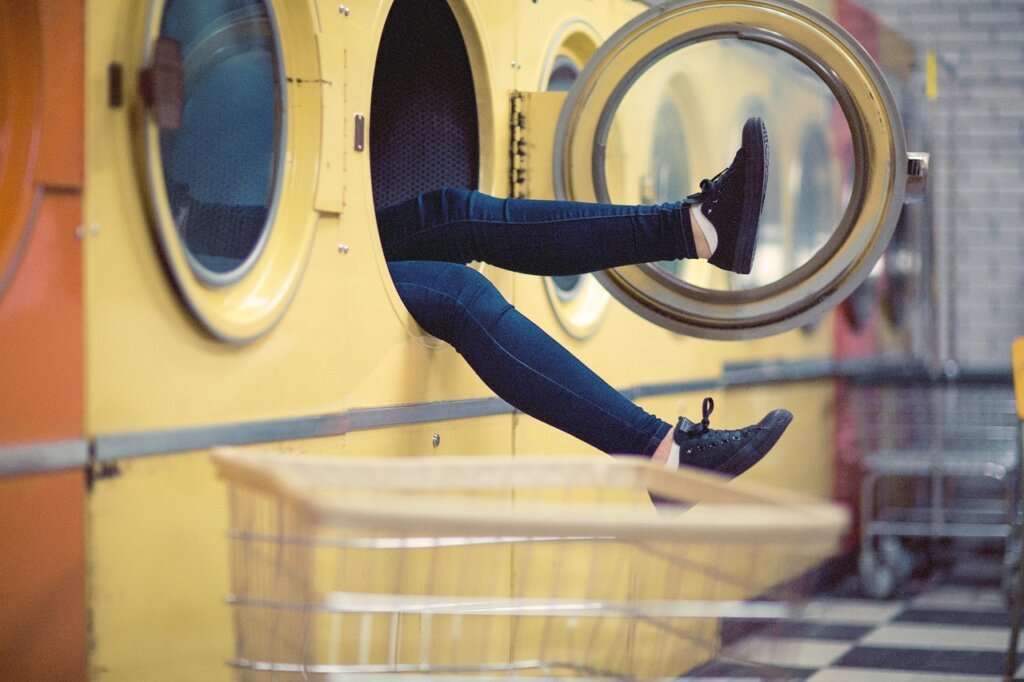 housewife cleaning washing machine rubber gasket with cloth