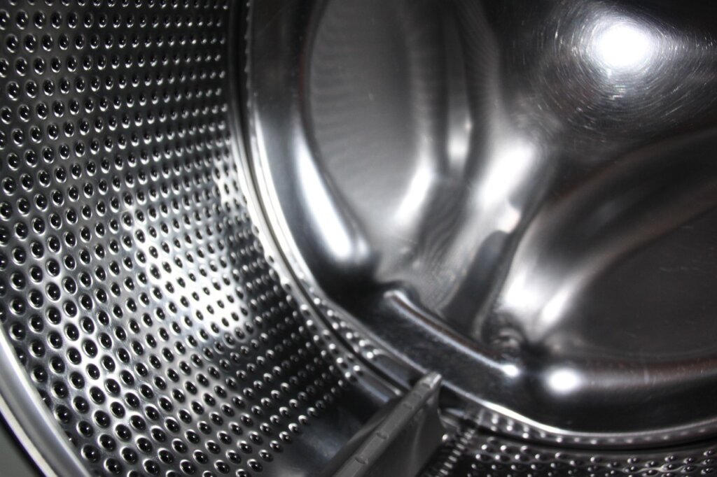 oxygen-based washing machine cleaner powder being poured into drum