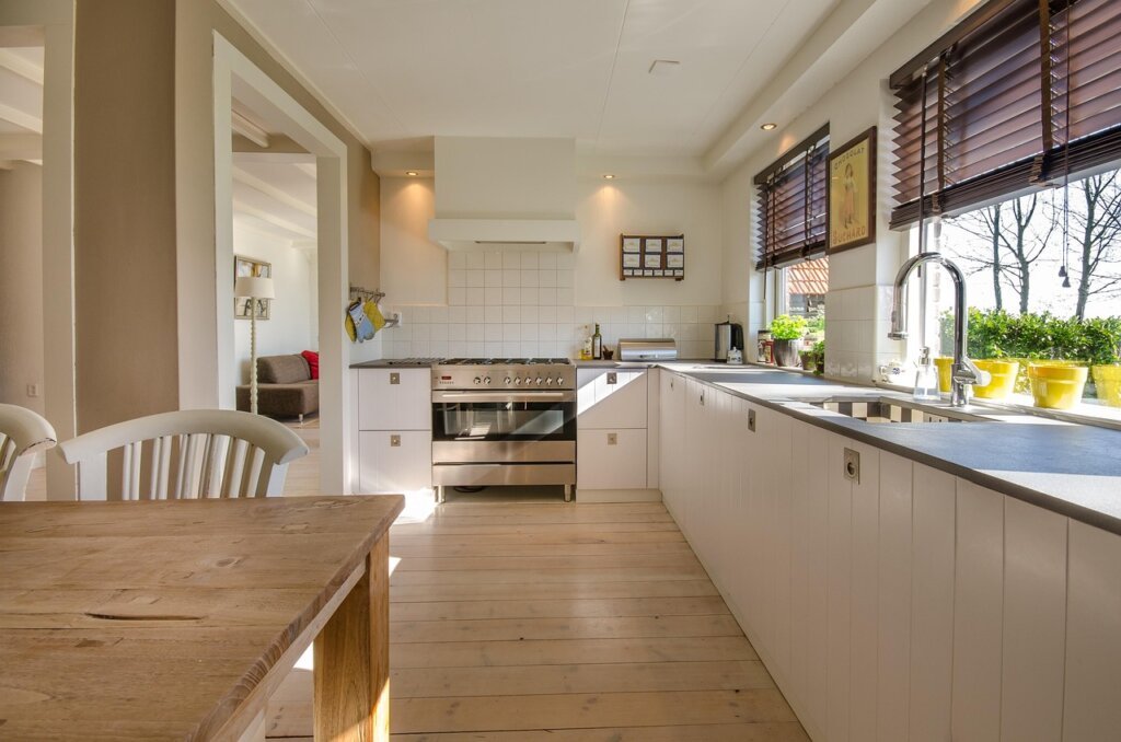 person cleaning kitchen counter on sunday evening, warm light