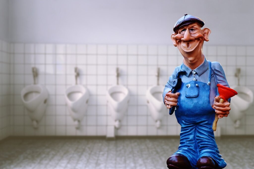 professional plumber inspecting bathroom drain with tools