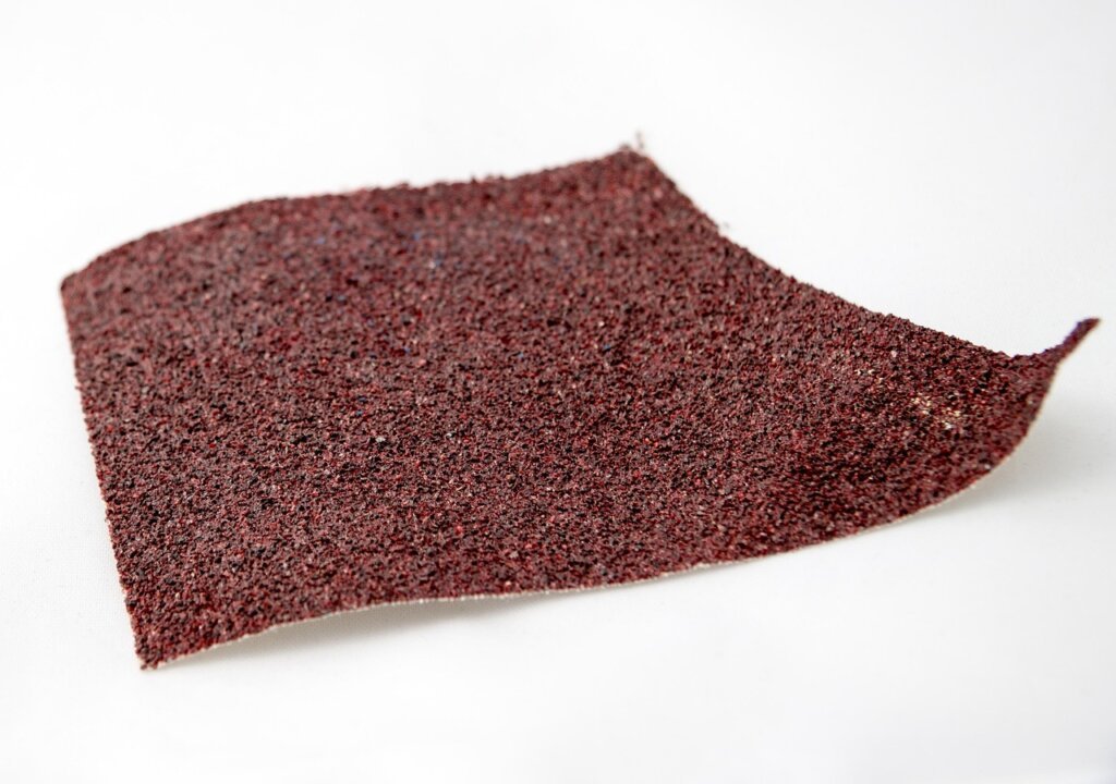 sanding a patched wall hole with fine sandpaper