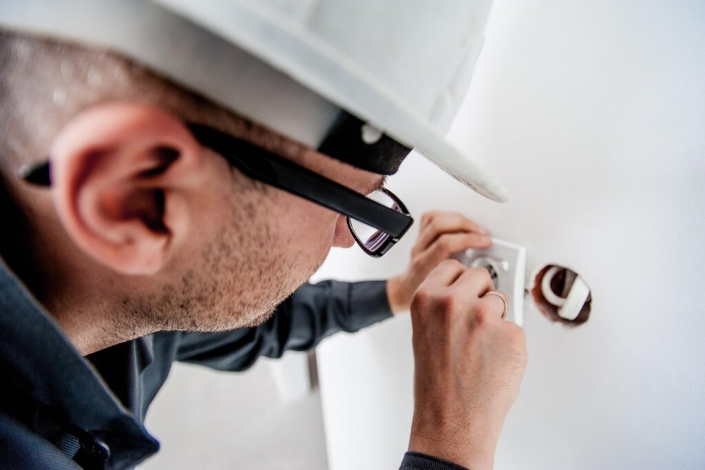 step by step nail hole repair process on white wall