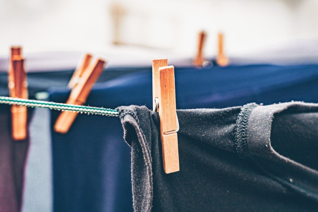 clothes drying flat on a mesh rack indoors