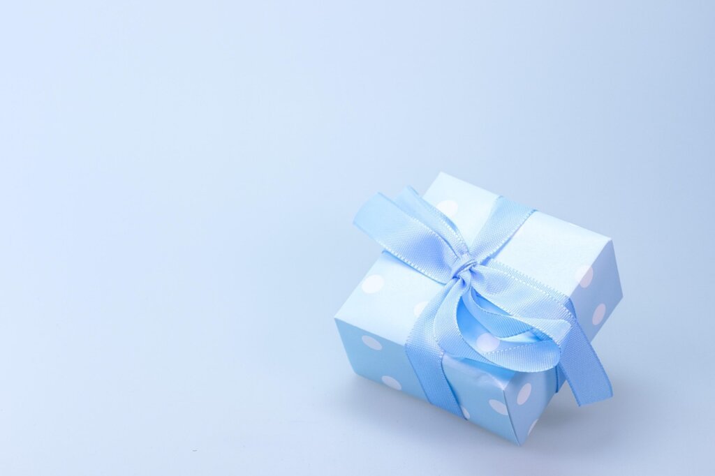 mother receiving a gift wrapped clothing box from adult child