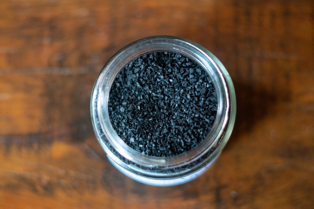 activated charcoal bag next to baking soda and coffee in refrigerator