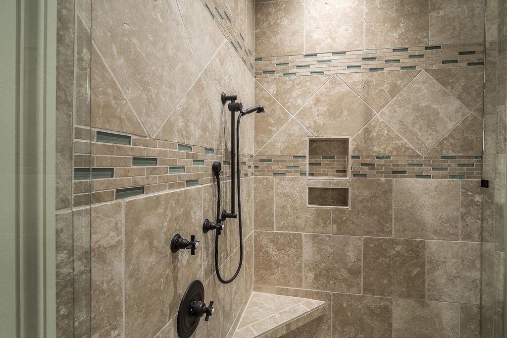squeegee wiping bathroom tile wall after shower