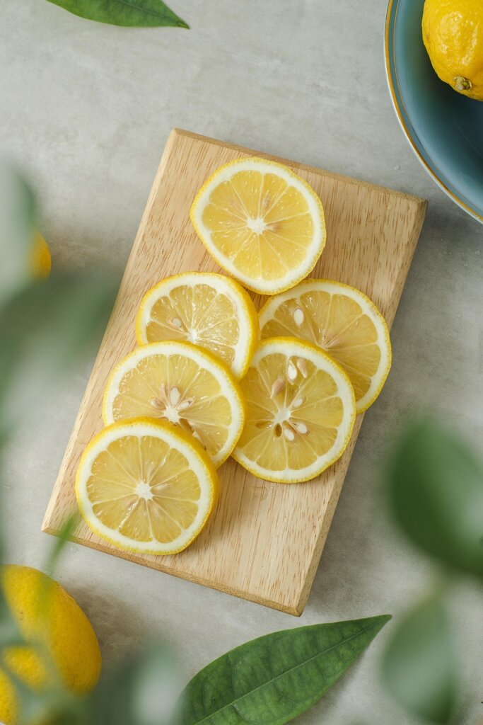white vinegar bottle and halved lemon on kitchen counter