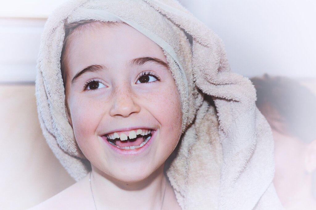 person smelling fresh clean towel and smiling