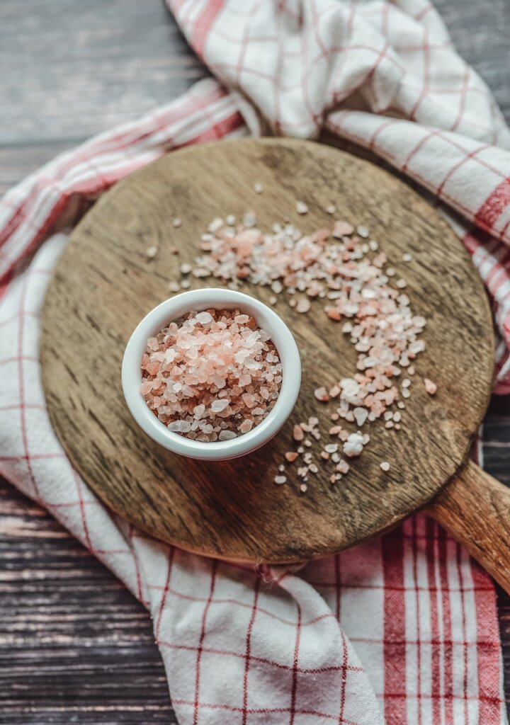 kitchen cloth soaking in baking soda solution in white bowl