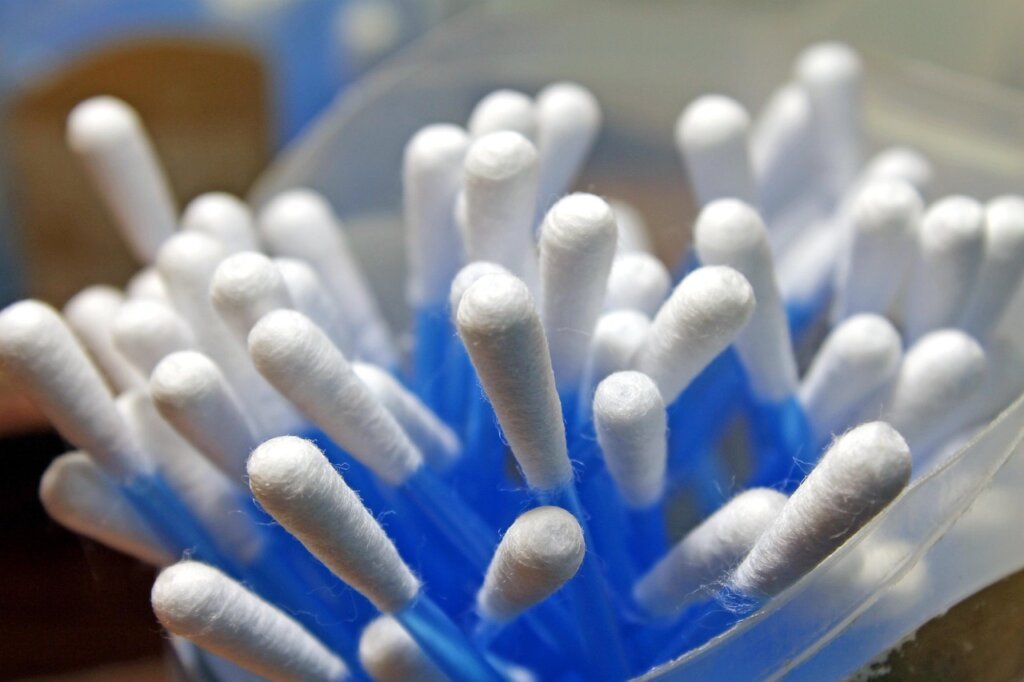 cotton swab cleaning around electrical socket