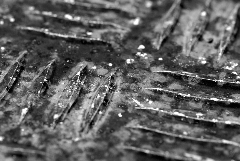 balcony drain grate with accumulated dust and debris