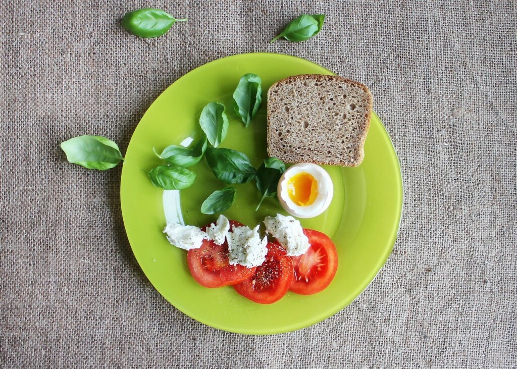 balanced meal prep with grains eggs salmon and greens in meal boxes