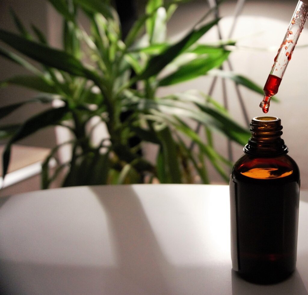 middle aged person taking vitamin B12 supplement with water