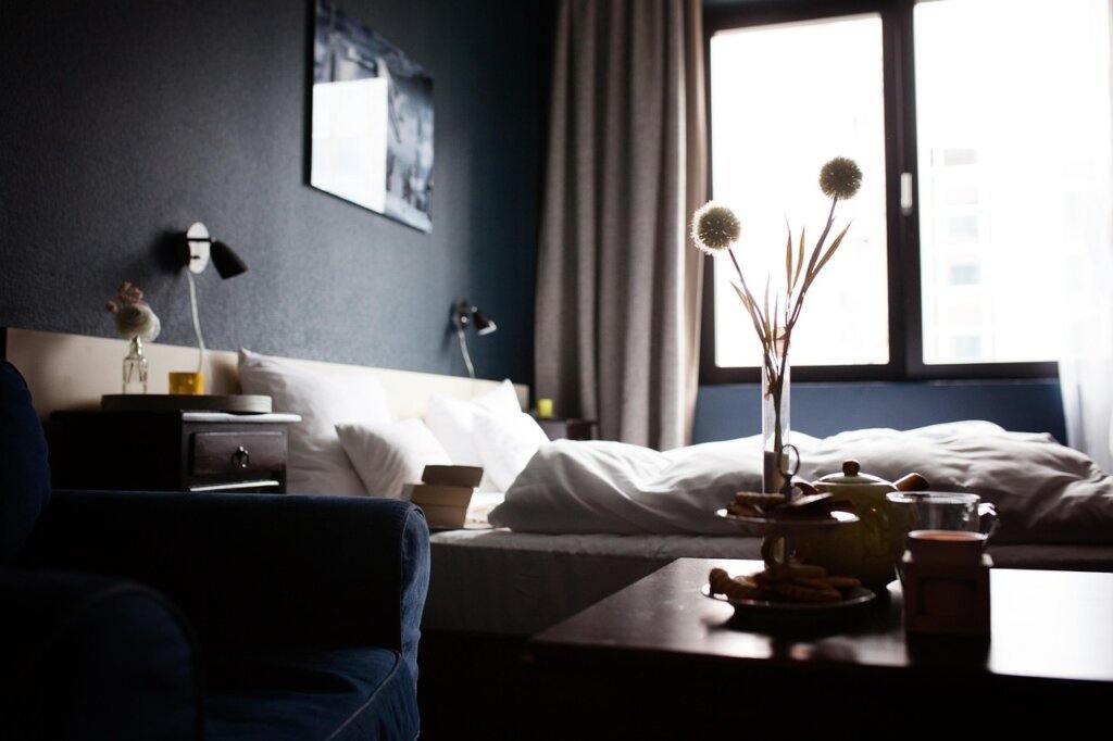 business traveler taking supplement with water in hotel room