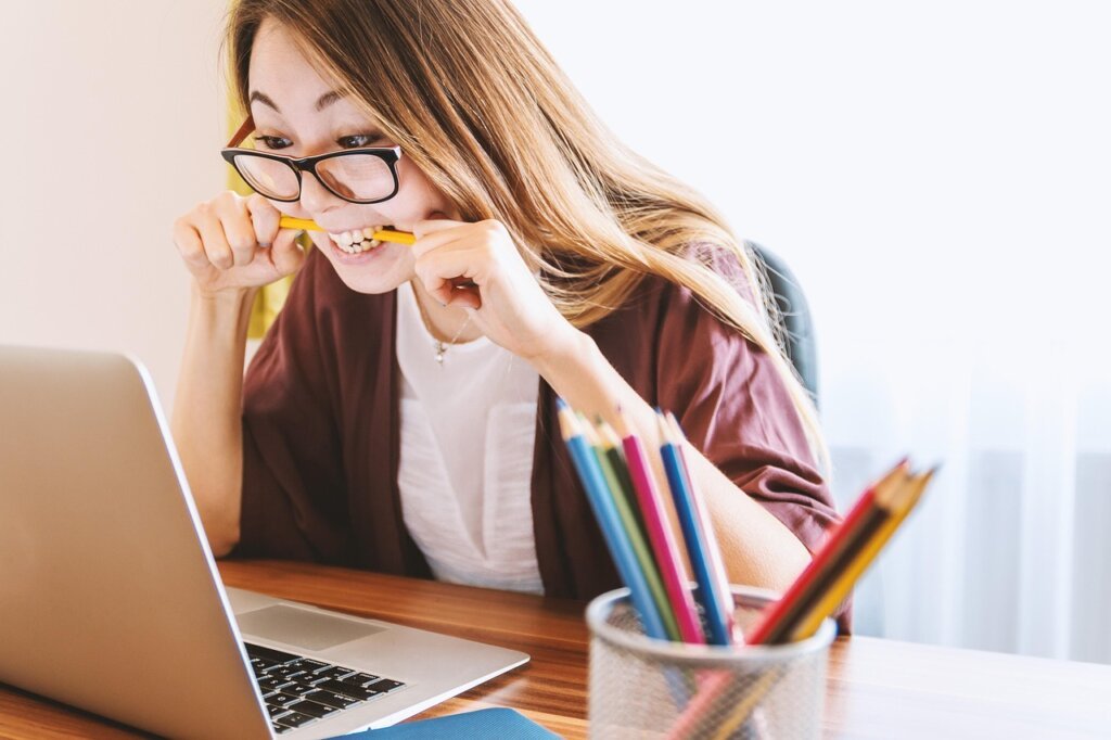 person feeling fatigue tired at desk studying