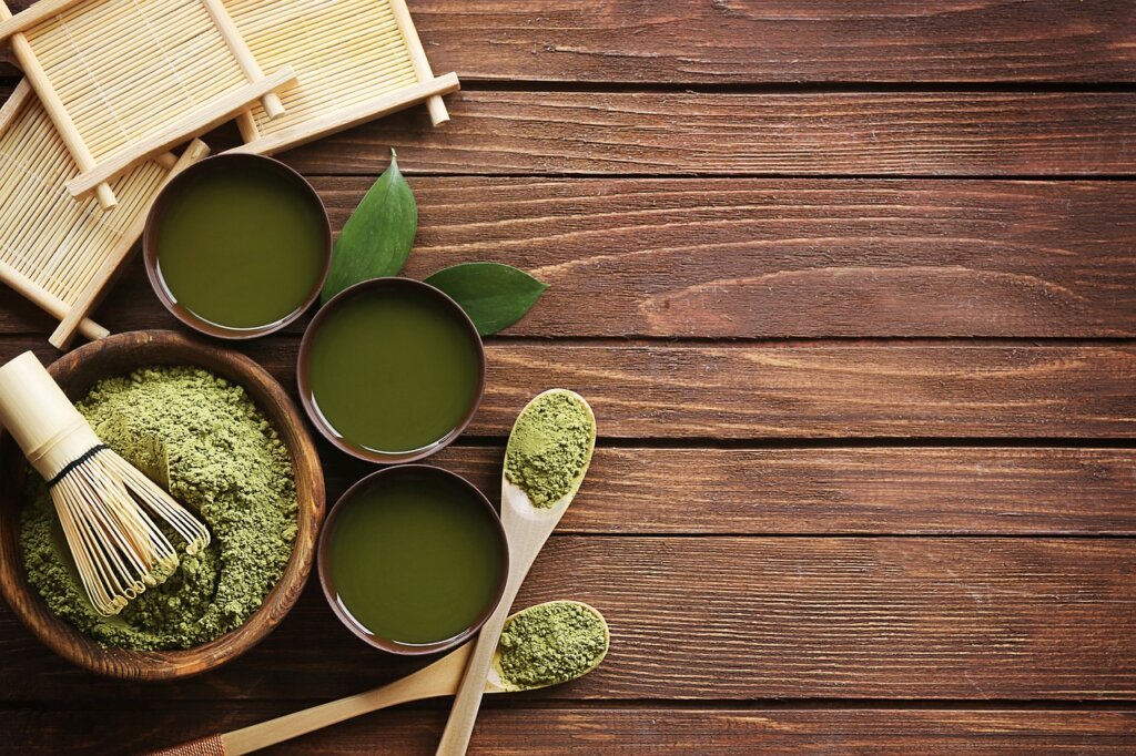 collagen supplement powder and capsules on wooden table