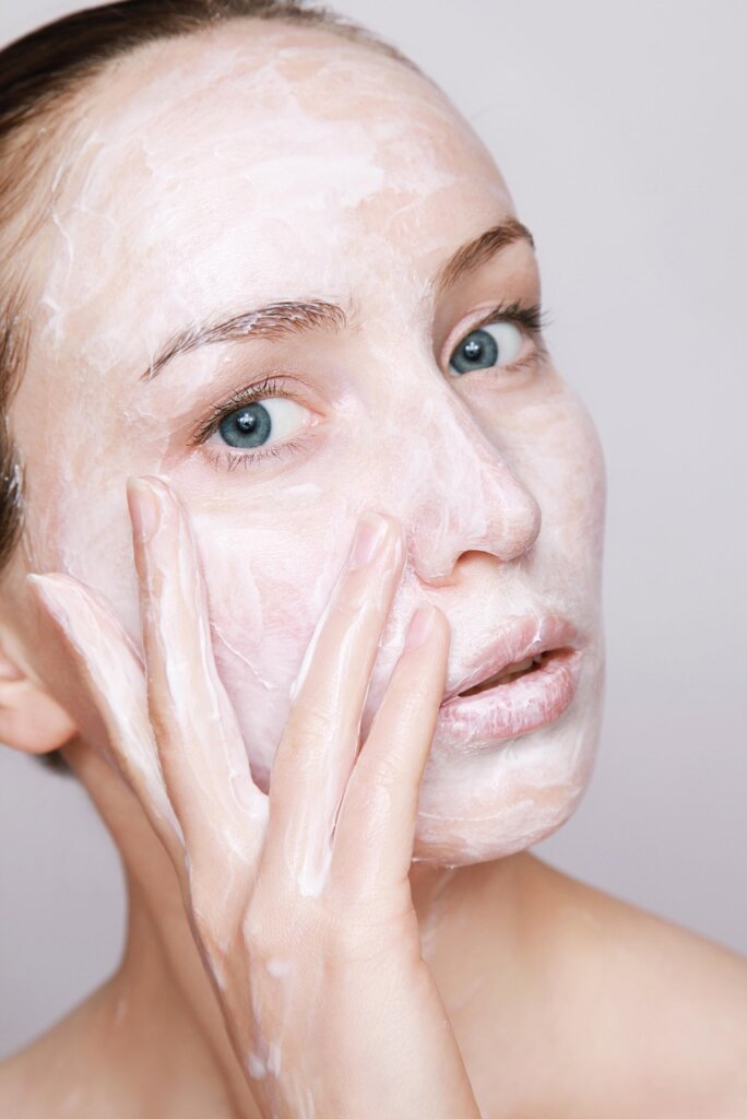 woman applying collagen cream healthy glowing skin