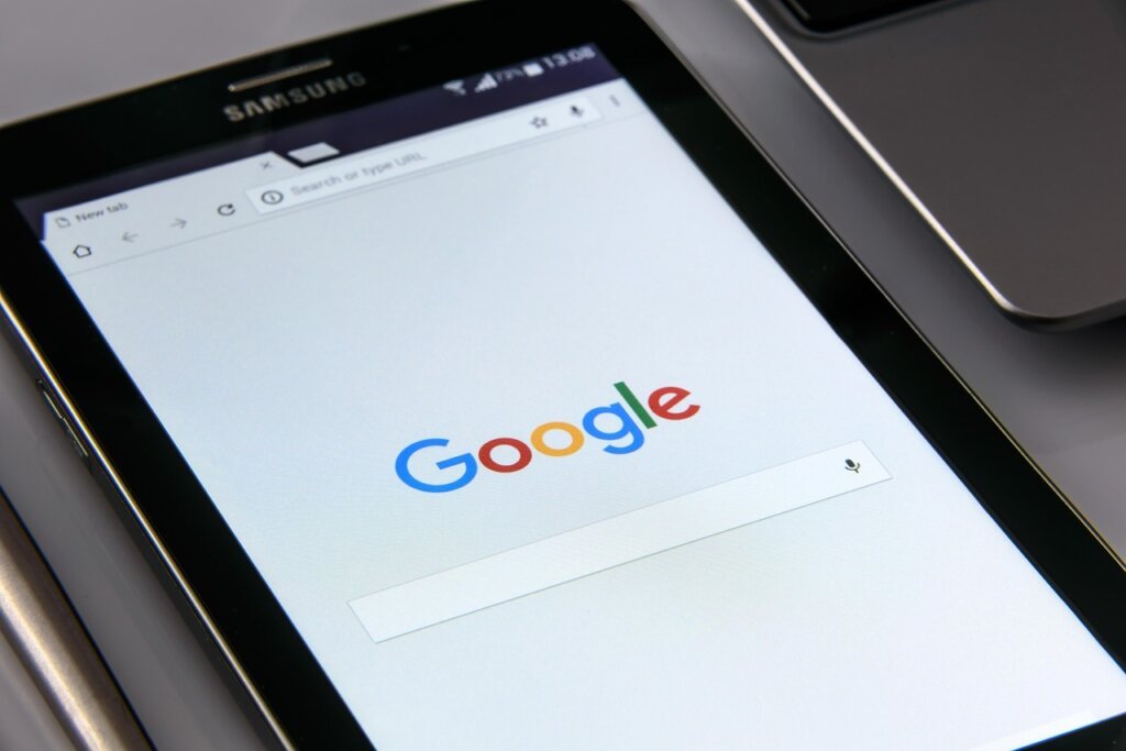 person checking health app on smartphone with supplement on desk