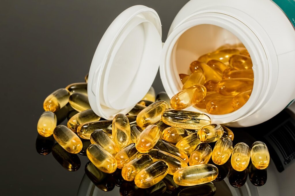 warning symbol next to supplement bottle with blood thinner medication