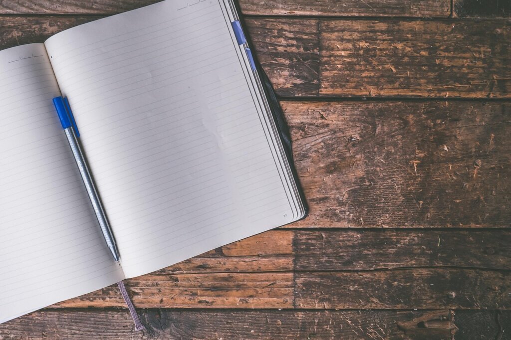 woman writing period tracking journal health diary