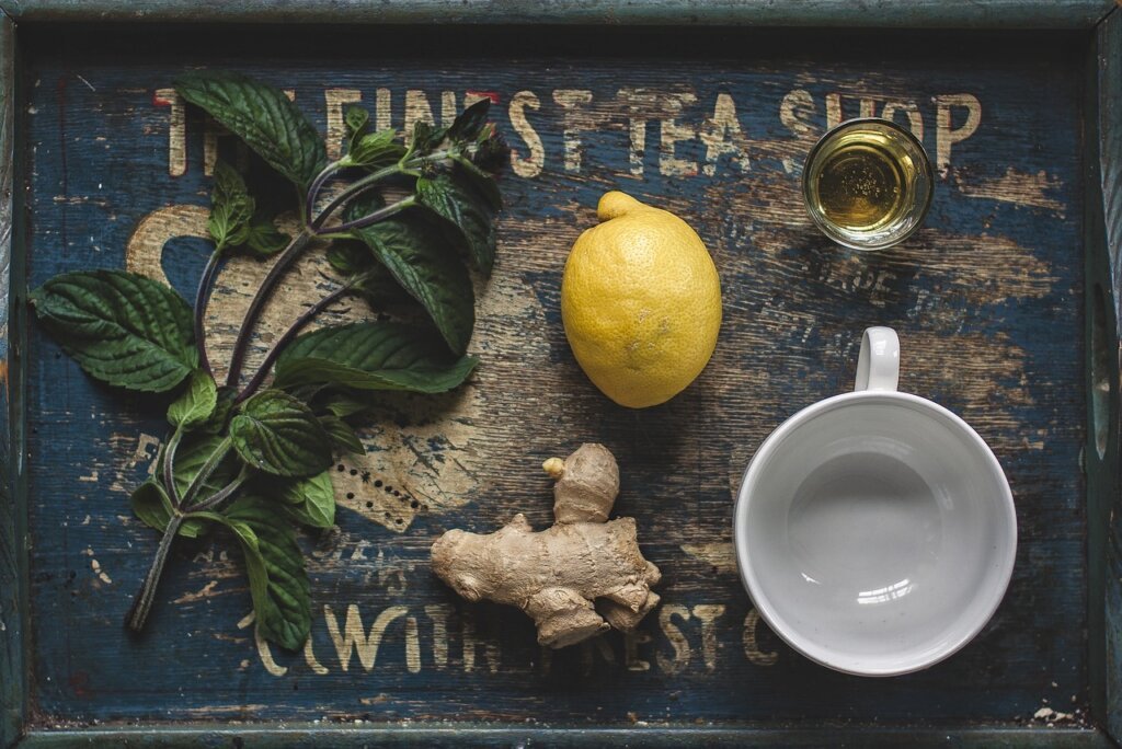 supplement capsules and green tea cup on wooden tray with morning light